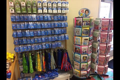 Walmart pin badges and lanyards are popular souvenirs for visitors to the town.